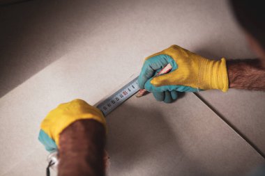 the master makes markings on the floor