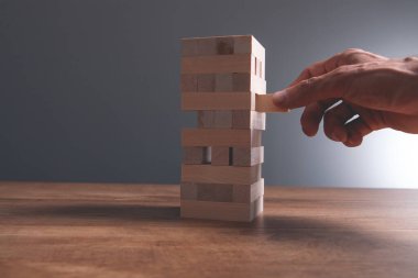 İşadamı eli tahta bloklara tahta küp koyuyor. iş başarısı ve strateji kavramı