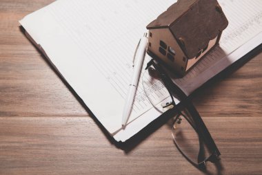 ev modeli ve defter masanın üstünde.