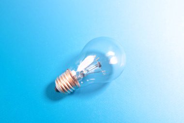 Light bulb on blue background, concept of new idea and innovation.