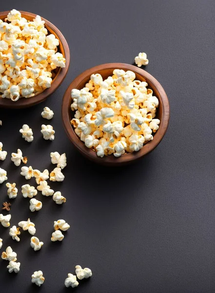 popcorn in a bowl on a black background. top view. free space for your text.