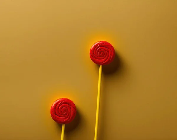 sweet lollipop on a stick on a yellow background.