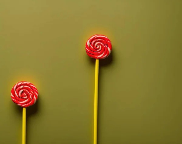 lollipop on a stick on a pink background.