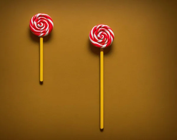 lollipop on a stick on a red background.