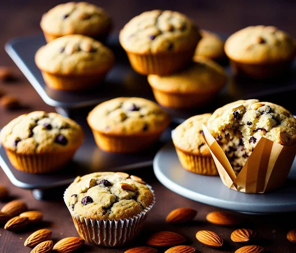 freshly baked muffins with chocolate chips on a wooden background.