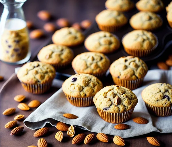 homemade muffins with chocolate chips and nuts on a wooden background