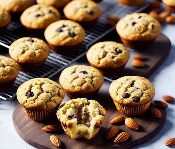 freshly baked muffins with chocolate chips and raisins on a wooden background.