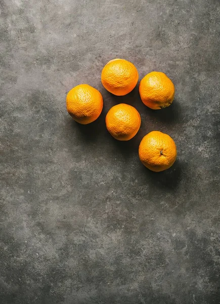 fresh ripe oranges on a black background. top view. copy space.
