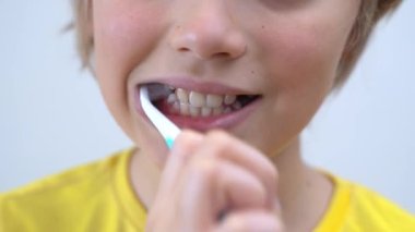 Close-Up Teenager Boy Brush Teeth Child Looking At Camera, Dentistry, Stomatology, Dental Care And Hygiene With Toothbrushes, Morning Evening Routine, Lifestyle, Health Care.