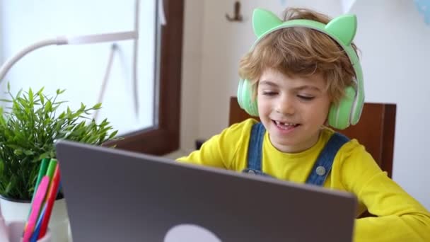 Schoolboy Child Using Laptop Headphones Online Educational Lesson Course Home — Stockvideo