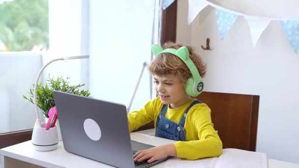Cute Smart Caucasian Primary School Child Headphones Educate Online Laptop — Stockvideo