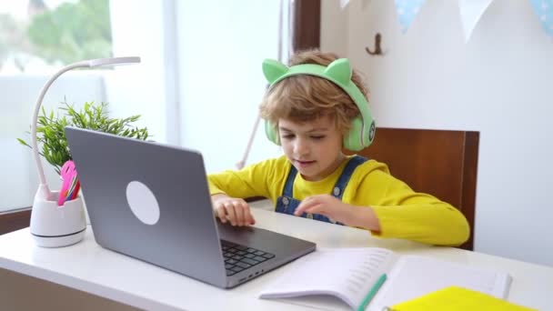 Cute Smart Caucasian Primary School Child Headphones Educate Online Laptop — Vídeos de Stock