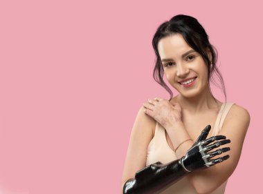 Slim Disabled Woman with Prosthetic Arm, Artificial Hand Smiling To Camera Over Pink Background. Women Beauty Diversity. Positive. Copy space clipart