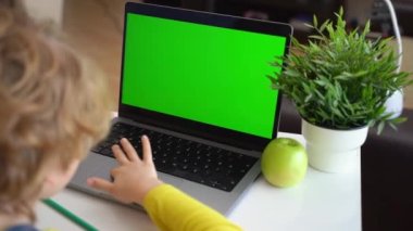 Close up Schoolboy child hands typing keyboard using touchscreen laptop online educational lesson course at home. Distance learning course remote video conference. Schoolgirl study does school