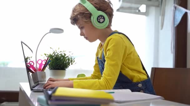 Schoolboy Child Using Laptop Headphones Online Educational Lesson Course Home — 图库视频影像