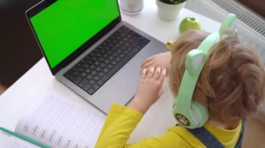 Close up Schoolboy child hands typing keyboard using touchscreen laptop online educational lesson course at home. Distance learning course remote video conference. Schoolgirl study does school