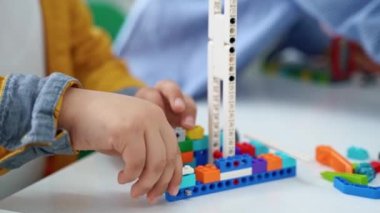 Robot programlama dersi. Çocuklar robot yapıp kodluyorlar. İnşaat blokları, dizüstü bilgisayar tableti, uzaktan kumandalı joystick kullanarak STEM eğitimi. Okul çocukları için teknolojik eğitim gelişimi