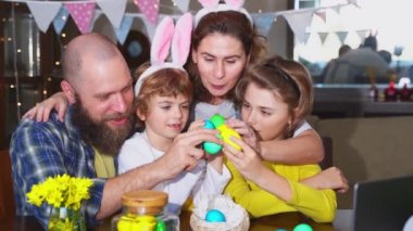 Happy family Easter tradition. Remote greeting relatives using laptop, painting egg, bunny ears. Christian religious holiday Sunday togetherness