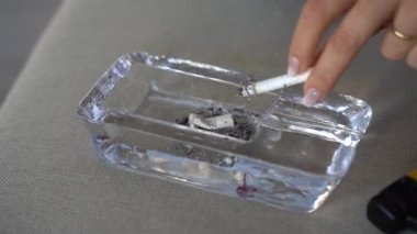 Close-up of extinguished cigarette butt in ashtray. Giving up smoking, non smoking day