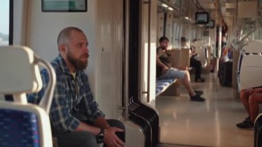 Yorgun adam esniyor, işten metroya biniyor. Banliyö sakini sabah erken saatlerde toplu taşıma araçlarıyla işe gider. Sırt çantalı adam metro kullanıyor. Toplu taşımacılıkta yetişkin.