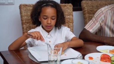 Afro-Amerikan beyaz aileler ve çocuklar hafta sonu birlikte öğle yemeği kahvaltısı yiyor. Aile geleneği, çocuklar için sağlıklı yiyecekler, boş zaman aktivitesi, bakım ve ilişkiler