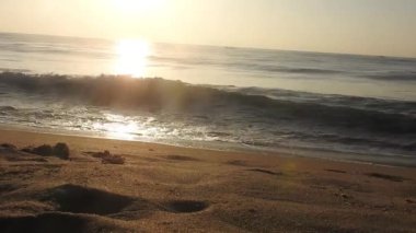 Güneşin doğuşunda balıkçıyla birlikte teknenin silueti Horizon Sunrise sahilinde güzel bir gün doğumu. Okyanus ve altın güneş doğuyor, parlak altın arka plan. Güneşin batışında dramatik bulutlu gökyüzünün olduğu güzel manzara. turuncu 