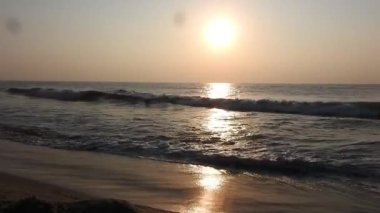 Balıkçı tekneleri eve dönüyor. Hindistan 'ın Odisha kentindeki Puri plajında güneş doğuyor. Doğayla güzel romantik bir manzara. Deniz sahilinde gün doğumunda balıkçı teknesiyle renkli bir gökyüzü. Dramatik deniz gündoğumu. Yanan gökyüzü ve parlayan dalgalar.