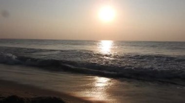 Balıkçı tekneleri eve dönüyor. Hindistan 'ın Odisha kentindeki Puri plajında güneş doğuyor. Doğayla güzel romantik bir manzara. Deniz sahilinde gün doğumunda balıkçı teknesiyle renkli bir gökyüzü. Dramatik deniz gündoğumu. Yanan gökyüzü ve parlayan dalgalar.