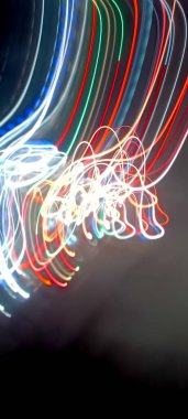 Soy 'da ışık yolları. Sanat eseri. Bir soyda uzun pozlama fotoğrafı. Mavi ve kırmızı ışıkta fotoğraf, uzun pozlu peri mavisi ve kırmızı ışıklar kıvrımlar ve dalgalar siyah arkaplanda. Uzun pozlu ışık resimli fotoğraf. Abs