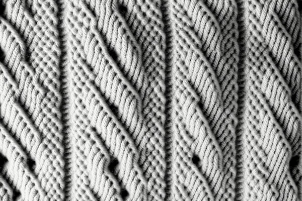 Seamless mottled light grey wool knit fabric background.