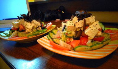Photography of a greek salad. Restaurant dish with tomatoes, curcumbers, cheese and vegetables. 