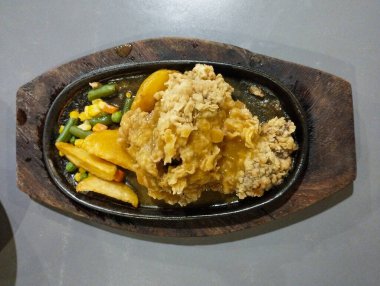 Fırında un ile kızartılmış sığır filetosu. Patates, bezelye, havuç ve sosla birlikte. Waroeng Biftek Bandung 'un orijinal mutfağı. Popüler et lokantalarından biri..