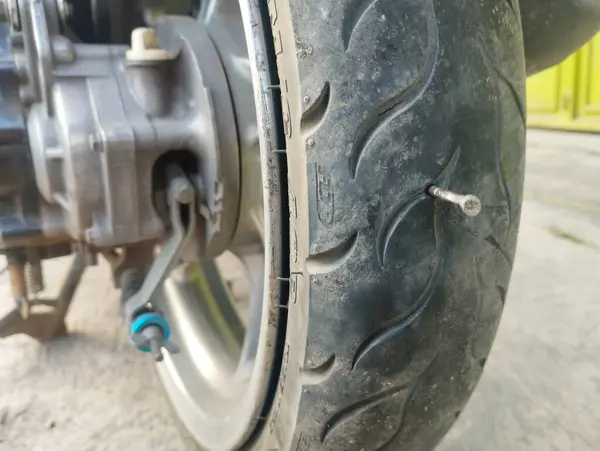 stock image Nails stuck in motorcycle tires