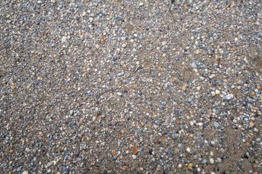 Gri küçük kayaların zemin dokusu. Siyah küçük yol taşı arka planı. Taş çakıl taşları, pürüzsüz doku, mermer. Ezilmiş granitin koyu arkaplanı