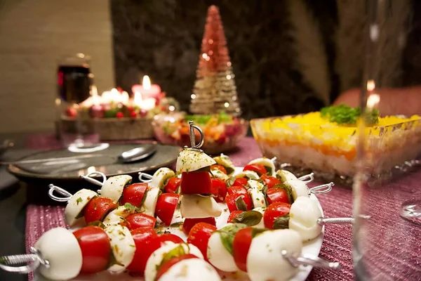 christmas table setting with tomato-mozzarella-pike snack