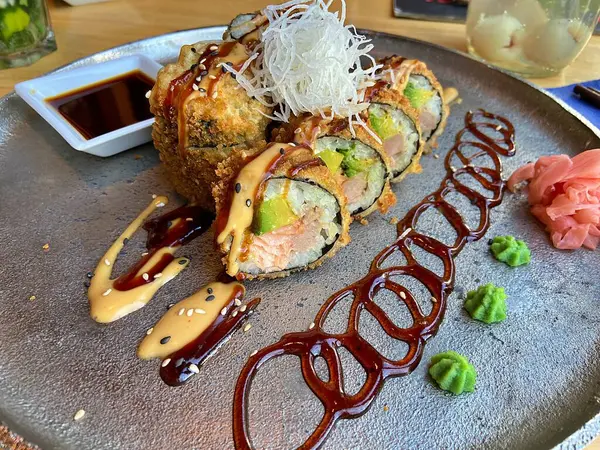 fried sushi rolls set on plate