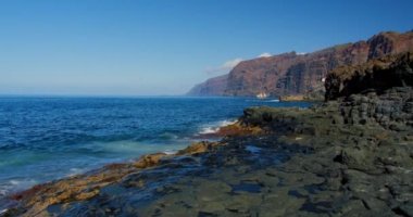 Lonely sailing yacht in the blue waters of the ocean. Against the blue sky. The concept of active recreation on the water and yachting. Canary Islands, Tenerife. Nobody.