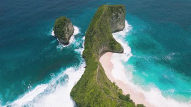 Breathtaking tropical Kelingking Beach Nusa Penida Island Bali. Scenery lagoon, sand shoreline and mountain cliff in ocean. Nature background. Indonesia. High quality 4K footage.