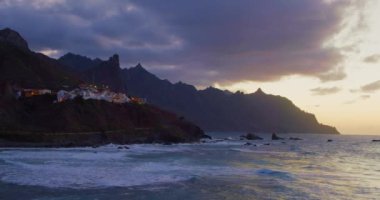 Beautiful golden sunset at the north of tenerife, Atlantic Ocean, Almaciga black sandy beach. Twilight.