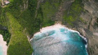 Turquoise sea water and tropical rocks on Kelingking beach Nusa Penida Island Bali Indonesia. Summer seascape. Ocean and cliffs. Famous touristic spot. Travel destination.