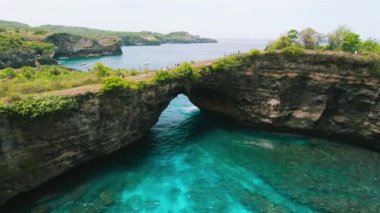 Nusa Penida island Bali Broken beach. Popular tourist destination. Travel to Southest Asia. Aerial view of unusual natural bridge on ocean coastline.