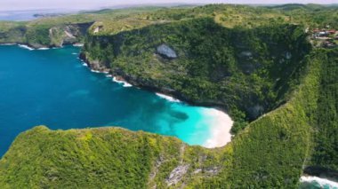 Turquoise sea water and tropical rocks on Kelingking beach Nusa Penida Island Bali Indonesia. Summer seascape. Ocean and cliffs. Famous touristic spot. Travel destination.
