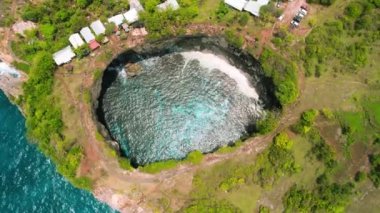 Tourist must visit Broken beach in Bali Island Indonesia. Aerial view of ocean and natural swimming pool with cliffs arch. Crystal clear turquoise sea water. Nusa Penida. Go everywhere.