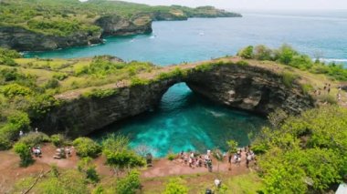 Nusa Penida island Bali Broken beach. Popular tourist destination. Travel to Southest Asia. Aerial view of unusual natural bridge on ocean coastline.
