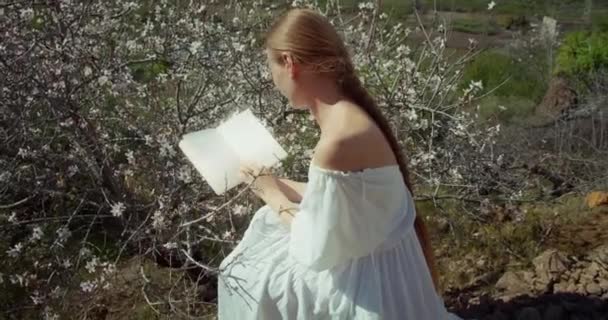 Young Woman Reading Diary Blossoming Cherry Tree Backlit Close Girl — Stock videók