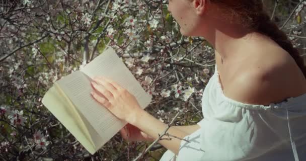 Young Woman Reading Diary Blossoming Cherry Tree Backlit Close Girl — Wideo stockowe