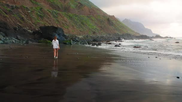 Young Woman Tourist Walks Black Volcanic Black Sand Beach Sunset — Stock Video