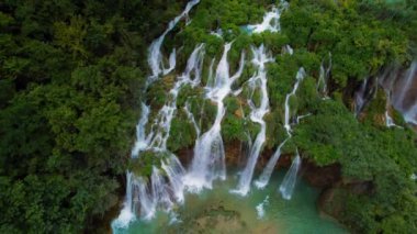 Güçlü şelale masmavi berrak suyla bir göle akar. Hırvatistan 'daki Plitvice Lakes Ulusal Parkı. Şelaleler ve kireçtaşı kanyonuyla birbirine bağlı 16 gölden oluşan bir şelale..