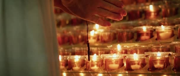 Female Hands Holding Wooden Religious Cross Burning Glowing Candles Temple — Stock Video
