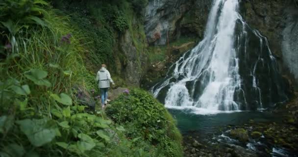 Woman Traveler Hiking Waterfall Highlands Raises Her Hands Enjoys Nature — Stock Video